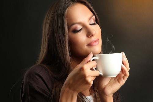Woman Smelling Coffee