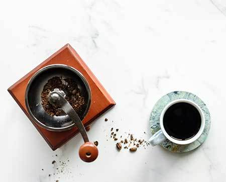 A Coffee Grinder and a Cup